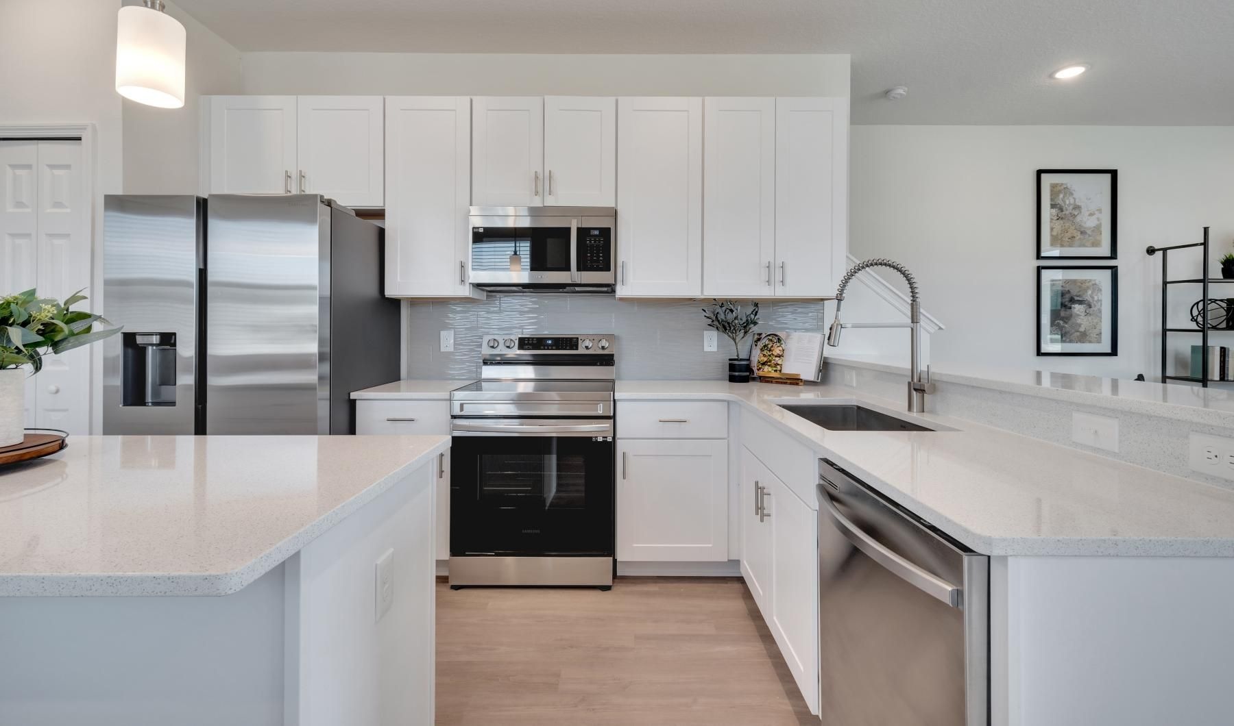 Spacious kitchens with thoughtful details a kitchen with white cabinets