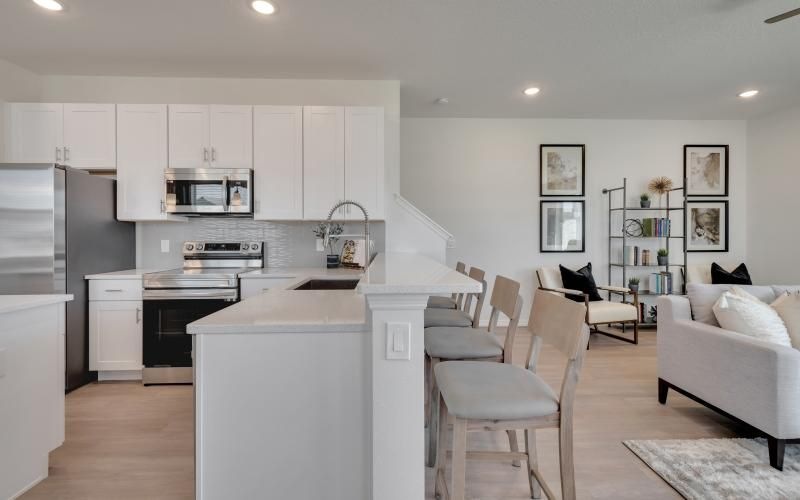 a kitchen next to a living room